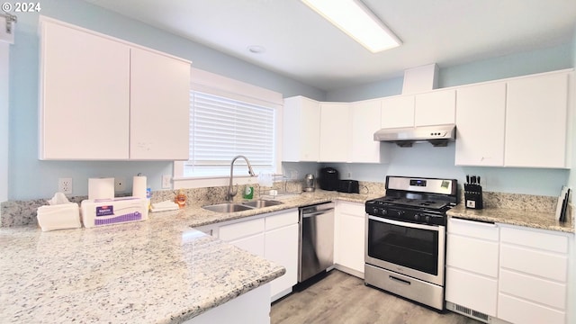 kitchen with sink, stainless steel appliances, light stone countertops, and white cabinetry