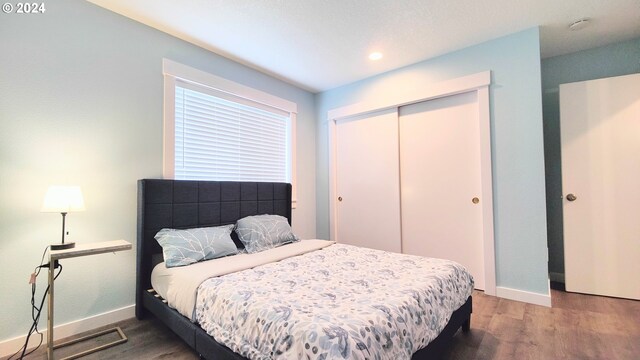 bedroom featuring hardwood / wood-style flooring and a closet