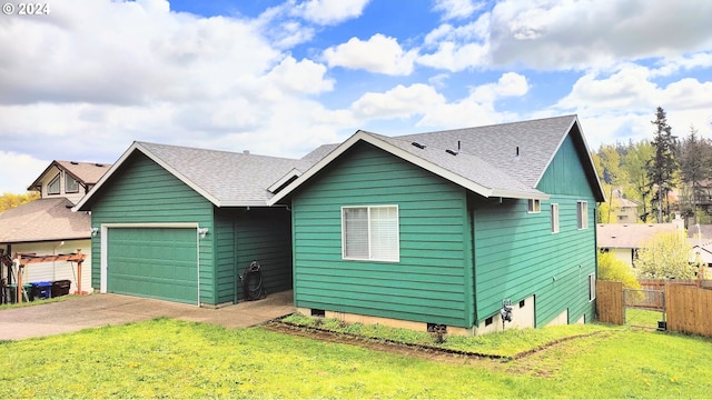 view of front of home with a front yard and a garage