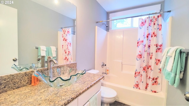 full bathroom featuring toilet, shower / tub combo with curtain, and vanity