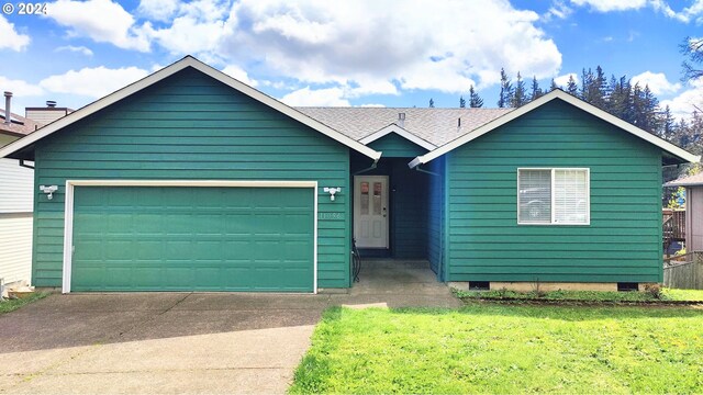 view of front facade featuring a front yard and a garage