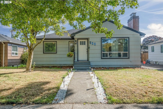 bungalow-style house with a front yard