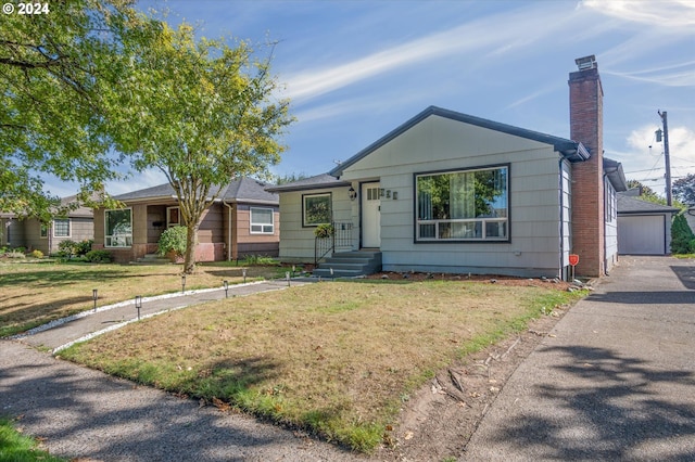 view of front of house with a front yard and a garage