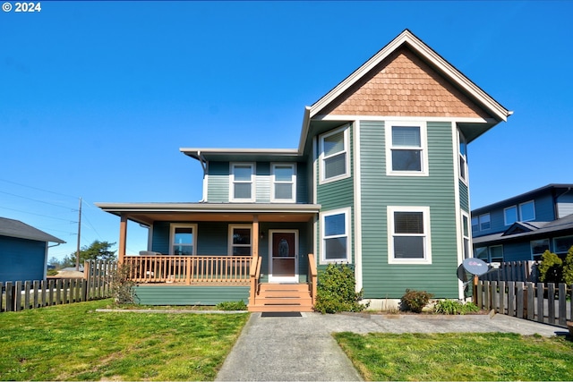 view of front of house with covered porch and a front lawn