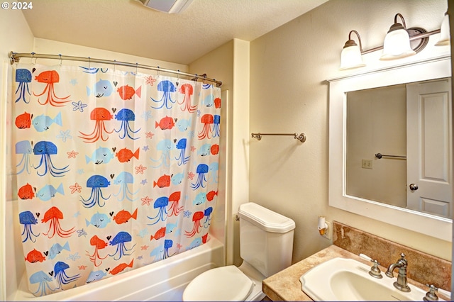 full bathroom featuring shower / bath combo, toilet, a textured ceiling, and large vanity