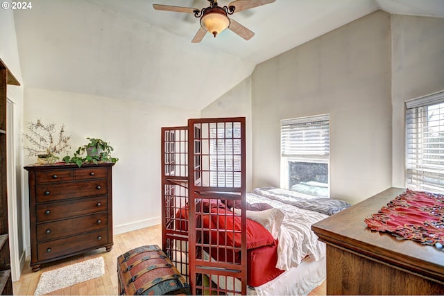 bedroom featuring light hardwood / wood-style floors, ceiling fan, and vaulted ceiling