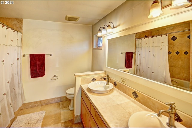 bathroom featuring dual sinks, tile flooring, toilet, and large vanity