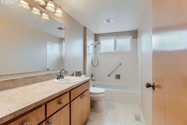 full bathroom featuring tiled shower / bath, toilet, and vanity