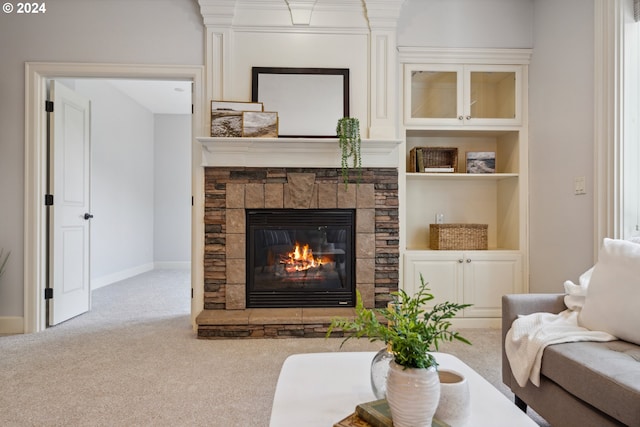 carpeted living room with built in features and a fireplace