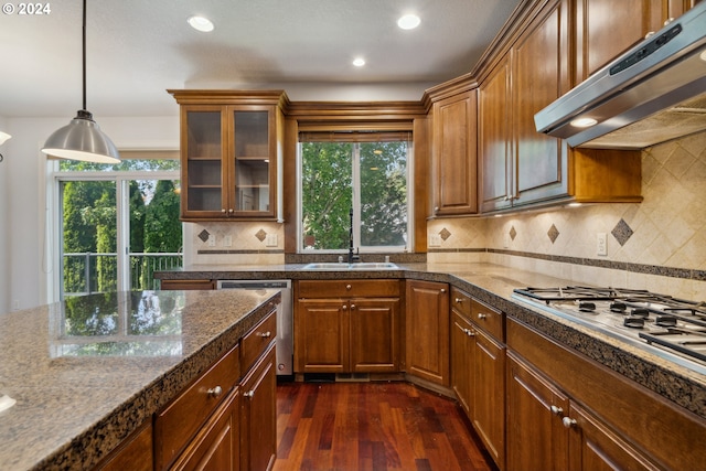 kitchen featuring white gas cooktop, hanging light fixtures, dark hardwood / wood-style flooring, dishwasher, and exhaust hood