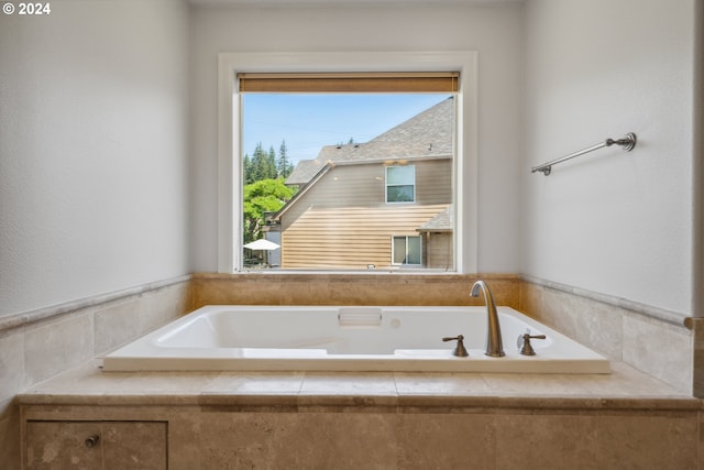 bathroom with tiled tub