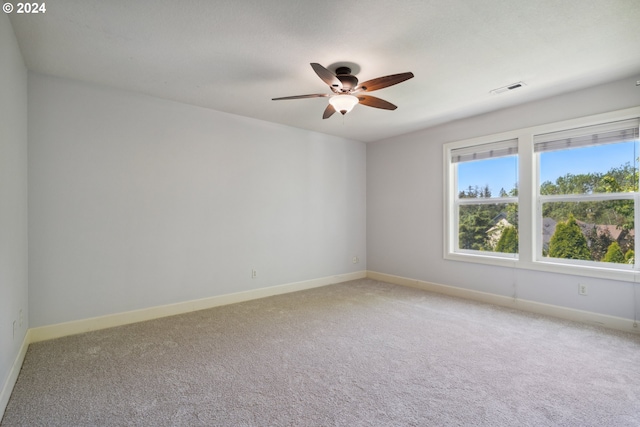 carpeted spare room with ceiling fan