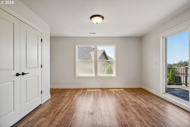 unfurnished dining area with wood-type flooring