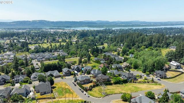 birds eye view of property with a water and mountain view