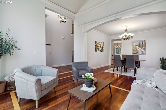 living room with an inviting chandelier, dark hardwood / wood-style flooring, and crown molding