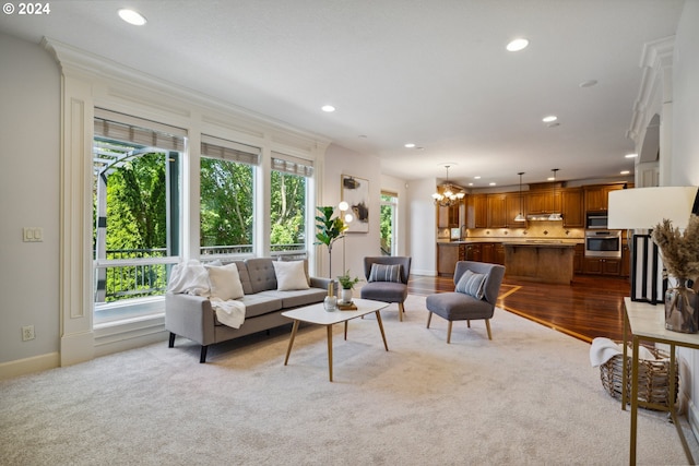 living room featuring light colored carpet and a notable chandelier