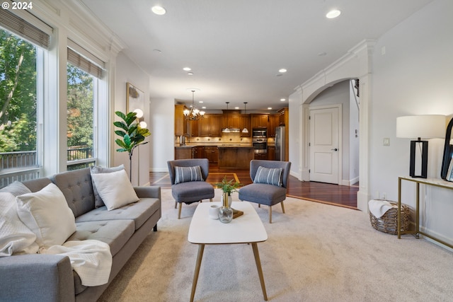 living room with an inviting chandelier and light hardwood / wood-style flooring