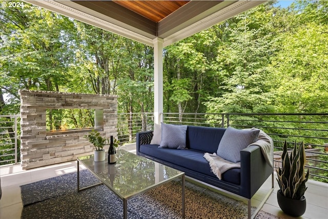 view of patio featuring an outdoor living space with a fireplace