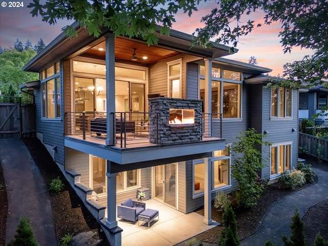 back house at dusk with a patio area