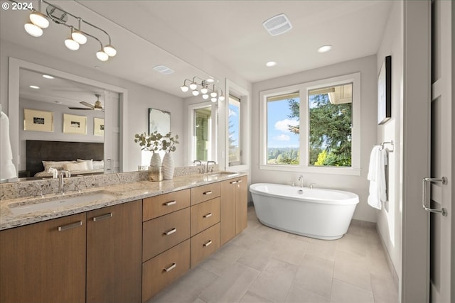 bathroom featuring ceiling fan, double sink vanity, tile patterned floors, and a tub