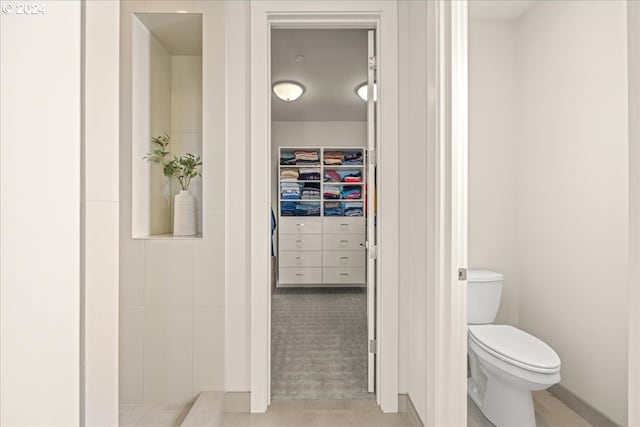 bathroom with toilet and tile patterned floors