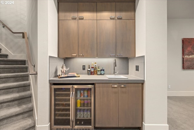 bar with wine cooler, tasteful backsplash, sink, and light colored carpet