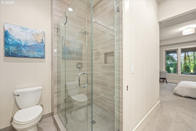 bathroom featuring an enclosed shower and toilet