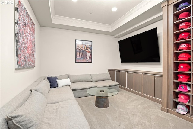 carpeted living room featuring a raised ceiling and crown molding