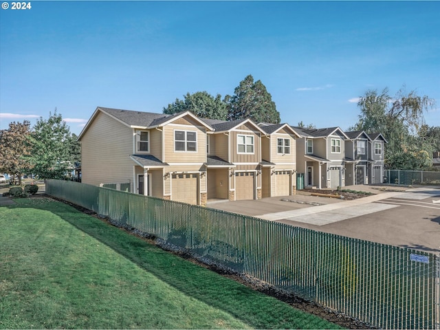 view of front of home with a garage and a front yard