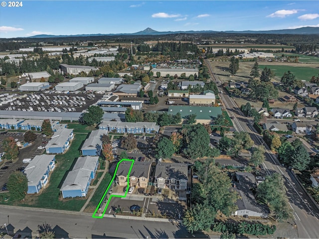 birds eye view of property with a mountain view