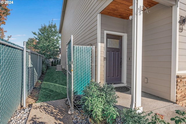 doorway to property featuring central air condition unit