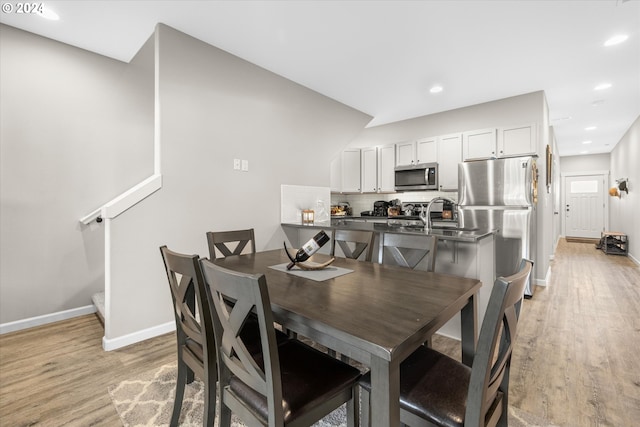 dining space featuring light wood-type flooring