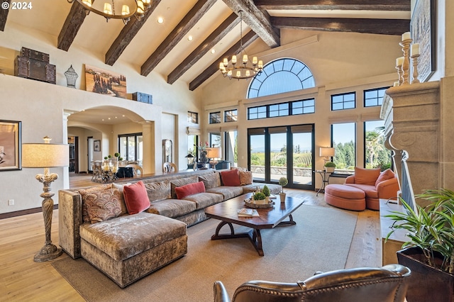 living room featuring an inviting chandelier, beamed ceiling, light hardwood / wood-style flooring, and high vaulted ceiling