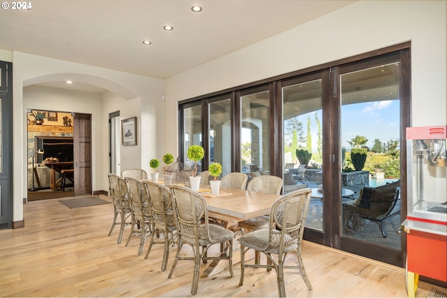 26590 SW French Oak Dr, West Linn, OR 97068 - dining room with french doors, recessed lighting, arched walkways, and light wood-type flooring