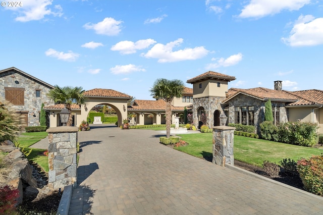 mediterranean / spanish home featuring a front lawn