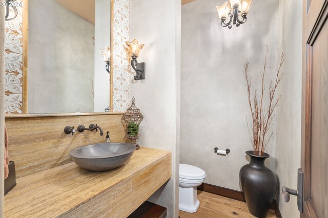 26590 SW French Oak Dr, West Linn, OR 97068 - half bath featuring toilet, wood finished floors, and a sink