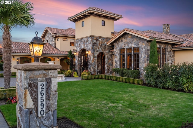 26590 SW French Oak Dr, West Linn, OR 97068 - mediterranean / spanish-style house featuring a lawn, stucco siding, a tiled roof, and stone siding