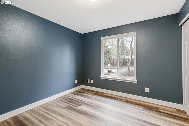 spare room with light wood-type flooring