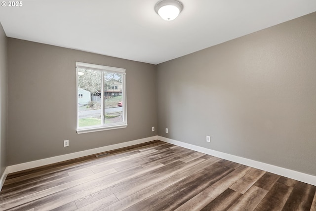 spare room featuring hardwood / wood-style flooring