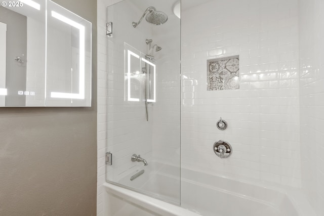 bathroom featuring shower / bath combination with glass door