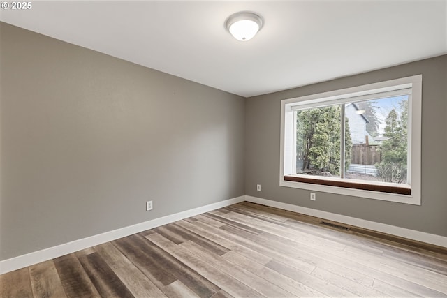 spare room featuring light hardwood / wood-style flooring