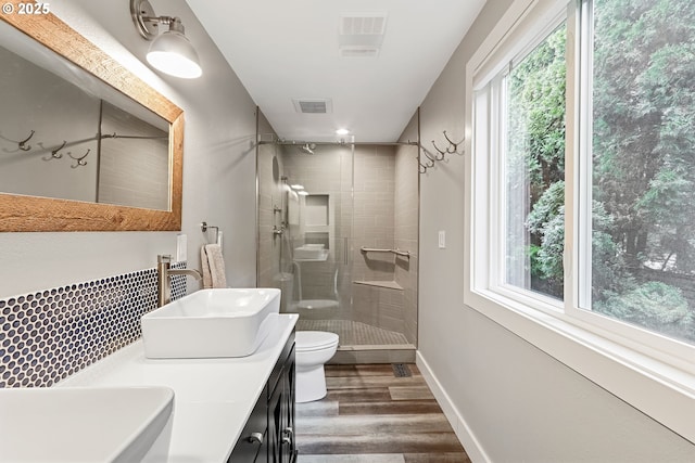 bathroom with vanity, toilet, wood-type flooring, and walk in shower