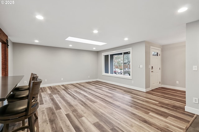 unfurnished living room with wood-type flooring