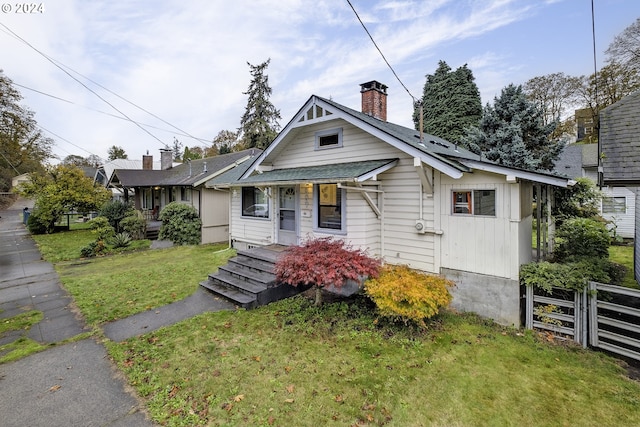 bungalow-style house with a front yard