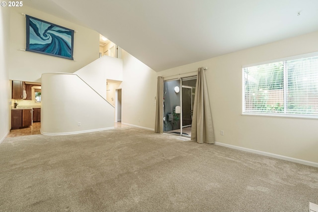 17760 NW Rolling Hill Ln, Beaverton, OR 97006 - unfurnished living room featuring light colored carpet, baseboards, and high vaulted ceiling