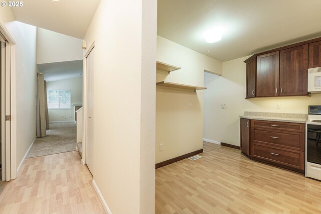 17760 NW Rolling Hill Ln, Beaverton, OR 97006 - kitchen featuring light wood finished floors, dark brown cabinetry, white microwave, and baseboards