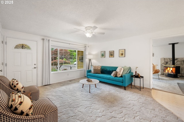266 NE 193rd Ave, Portland, OR 97230 - living area with carpet, a wood stove, a ceiling fan, and a textured ceiling