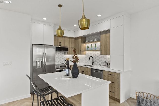 kitchen featuring hanging light fixtures, a kitchen island, white cabinets, exhaust hood, and appliances with stainless steel finishes