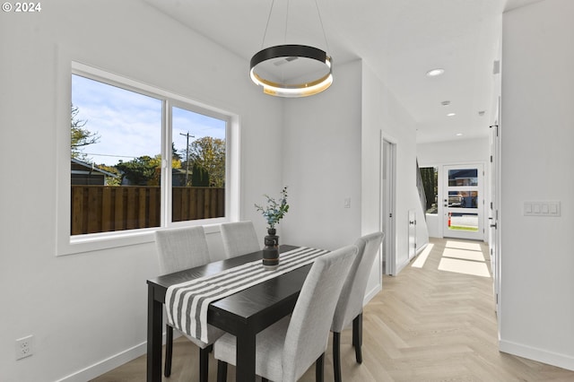 dining space with light parquet flooring