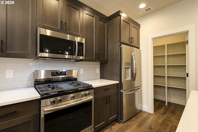 kitchen with backsplash, dark hardwood / wood-style flooring, stainless steel appliances, and dark brown cabinets